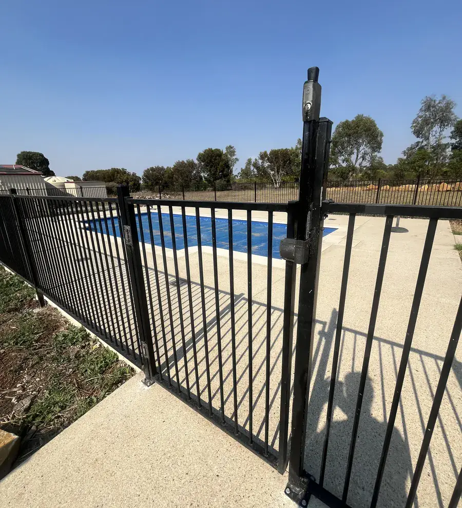 A black aluminium pool safety fence around a pool in a regional Victorian backyard